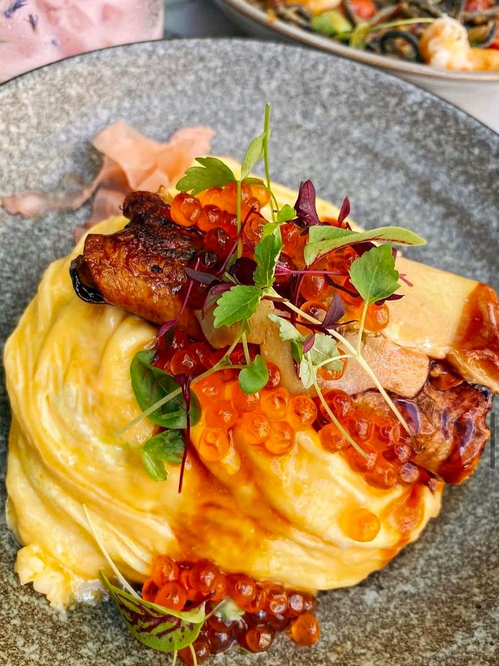 A salmon and soft egg brunch plate topped with microgreens