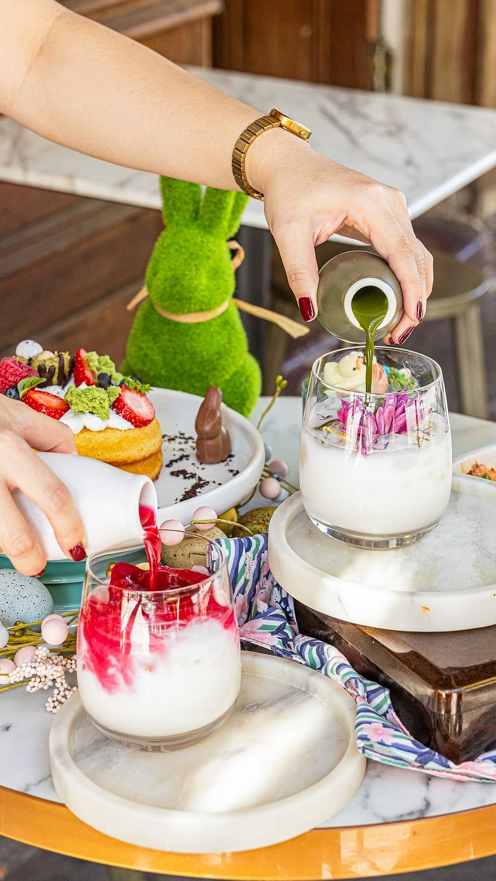 Matcha being poured over ice with fresh strawberries