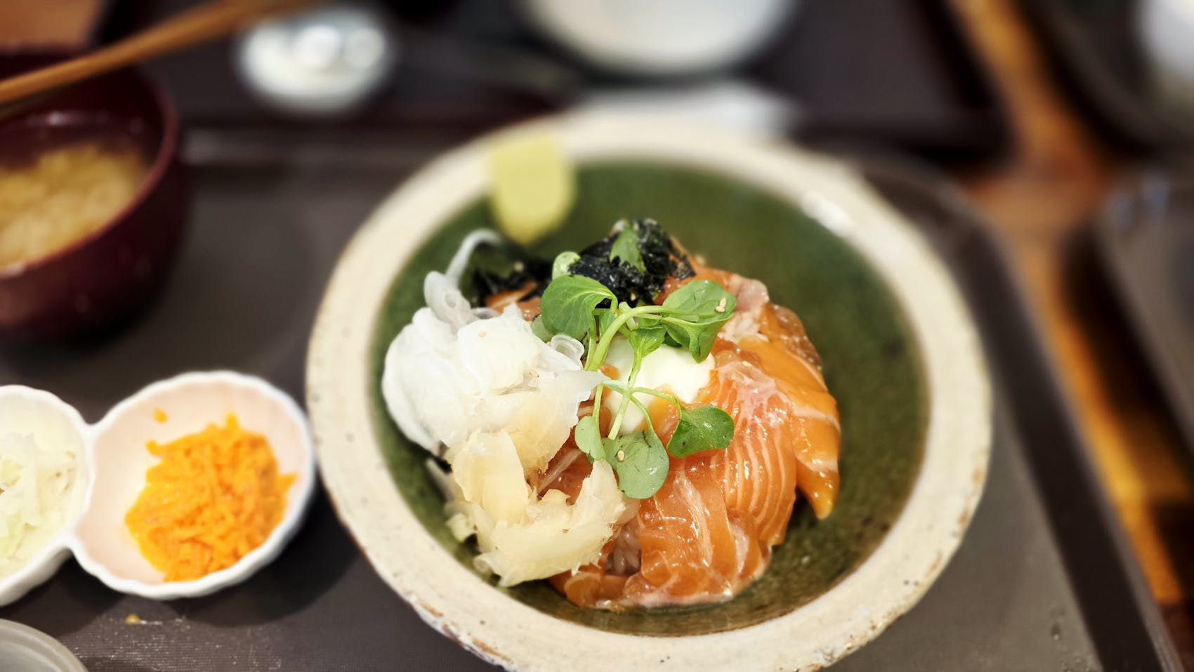 A beautifully plated salmon sashimi bowl with microgreens